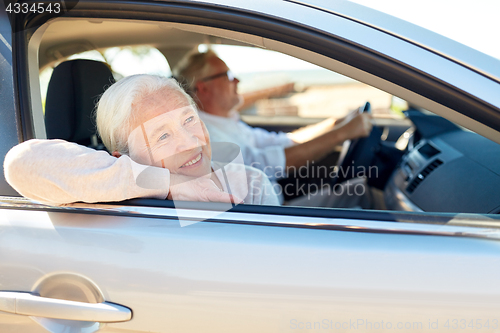 Image of happy senior couple driving in car