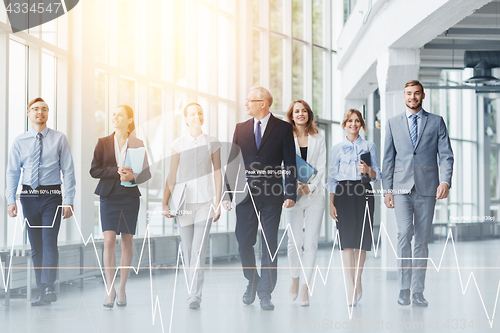 Image of business people walking along office building