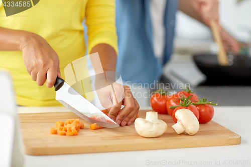 Image of close up of african woman hands cooking food