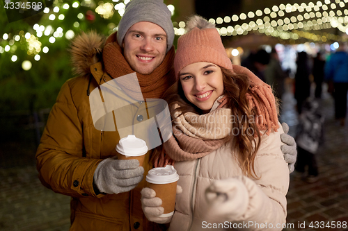 Image of couple with coffee taking selfie at christmas