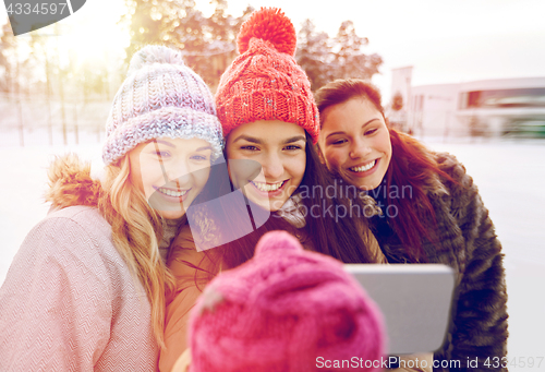 Image of happy teenage girls taking selfie with smartphone