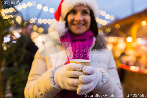 Image of woman with cup of hot drink at christmas market