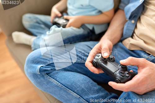Image of close up of father and son playing video game
