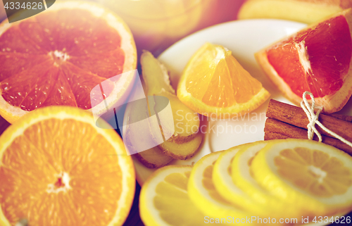 Image of honey, citrus fruits, ginger and cinnamon