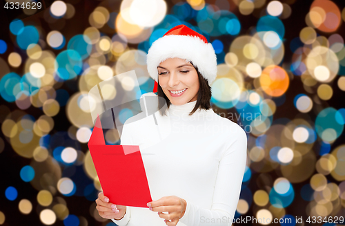 Image of happy woman reading christmas greeting card