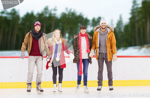 Image of friends holding hands on outdoor skating rink