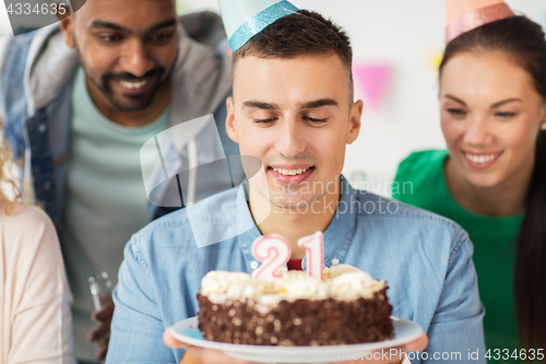 Image of man with birthday cake and team at office party