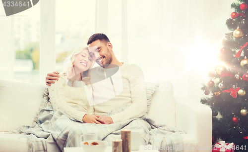 Image of happy couple at home with christmas tree