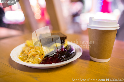 Image of braised cabbage and sausages with sauce on plate