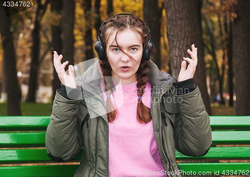 Image of Surprised young girl with headphones