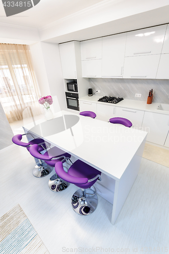 Image of white dining table in modern kitchen