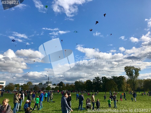 Image of Hundreds of kites are soaring in the sky during the kite festival on the German Reunification Day