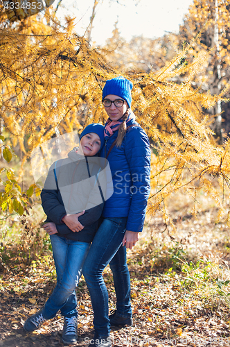 Image of Mother and son at autumn park