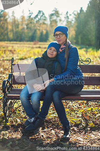 Image of Mother and son at autumn park