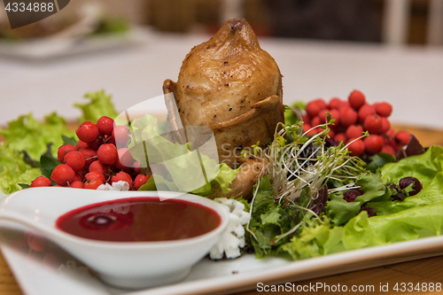 Image of quail roasted with sweet and sour cranberry sauce