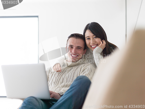 Image of multiethnic couple using laptop computers