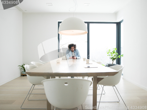 Image of man using a mobile phone  at home