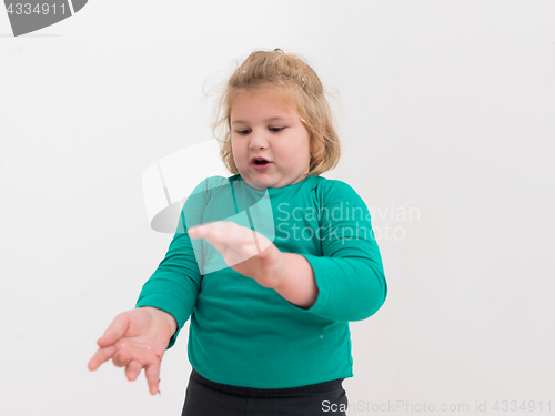 Image of kid blowing confetti