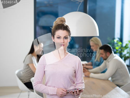 Image of Portrait of  smiling casual businesswoman using tablet  with cow