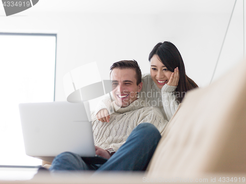 Image of multiethnic couple using laptop computers