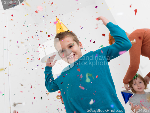 Image of kids  blowing confetti