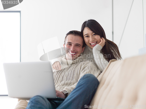 Image of multiethnic couple using laptop computers