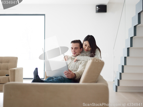 Image of multiethnic couple using laptop computers