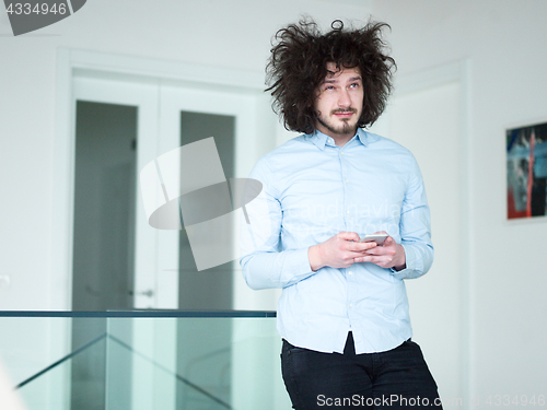 Image of man using a mobile phone  at home