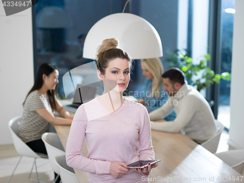 Image of Portrait of  smiling casual businesswoman using tablet  with cow