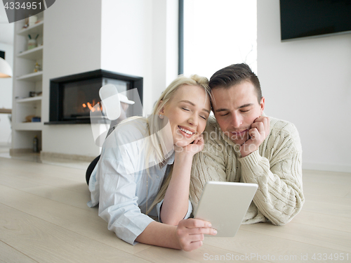 Image of Young Couple using digital tablet on cold winter day