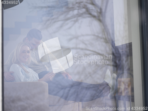 Image of Couple using digital tablet on cold winter day