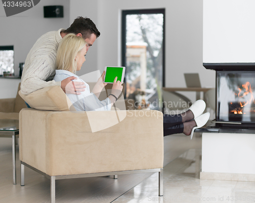 Image of Couple using digital tablet on cold winter day