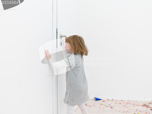 Image of Little girl standing on confetti