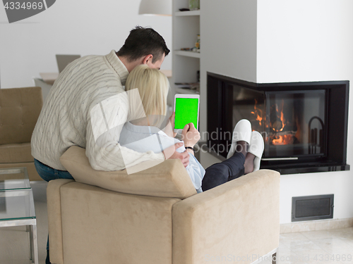 Image of Couple using digital tablet on cold winter day