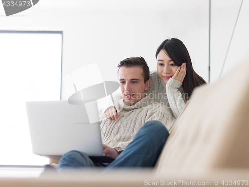 Image of multiethnic couple using laptop computers