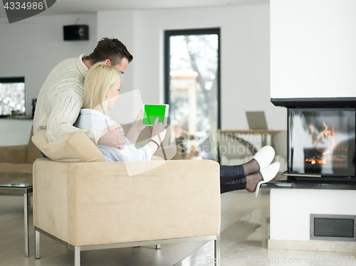 Image of Couple using digital tablet on cold winter day