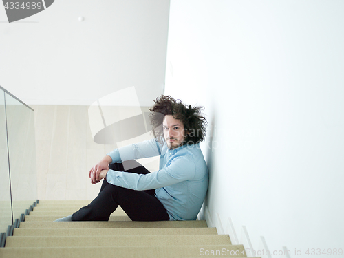 Image of young man sitting on the stairs