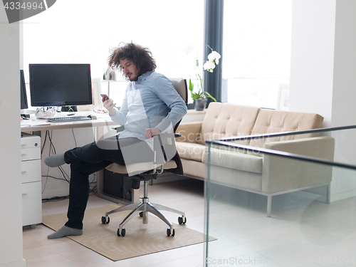 Image of man using a mobile phone  at home