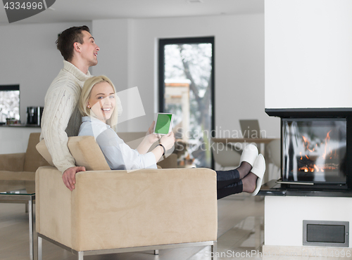 Image of Couple using digital tablet on cold winter day