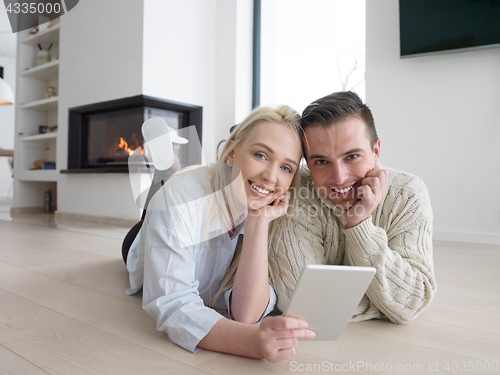 Image of Young Couple using digital tablet on cold winter day