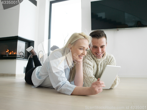 Image of Young Couple using digital tablet on cold winter day