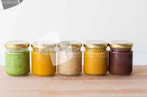 Image of vegetable or fruit puree or baby food in jars