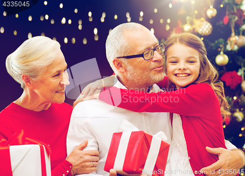 Image of happy family with christmas gifts