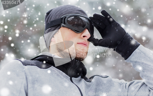 Image of close up of sports man with ski goggles in winter