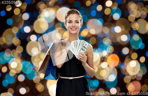 Image of smiling woman in dress with shopping bags