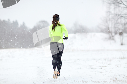 Image of woman running outdoors in winter