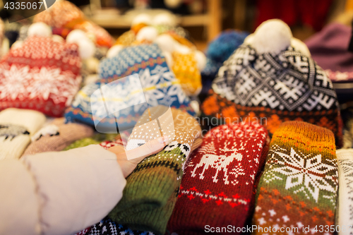 Image of woman buying woolen mittens at christmas market