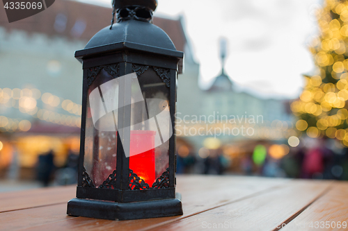 Image of close up of christmas lantern with burning candle