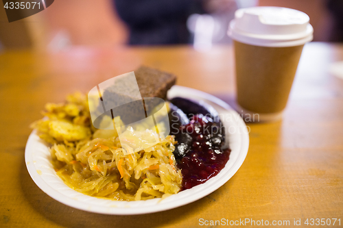 Image of braised cabbage and sausages with sauce on plate