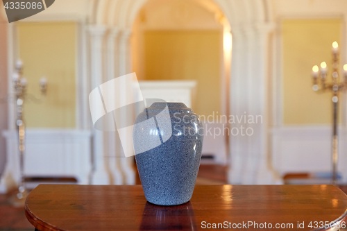 Image of cremation urn on table in church